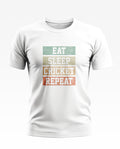 White men's t-shirt with 'Eat Sleep Cricket Repeat' printed in colorful bold text.