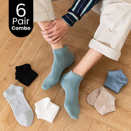 Men wearing pastel ankle socks, six pair combo pack displayed on wooden floor