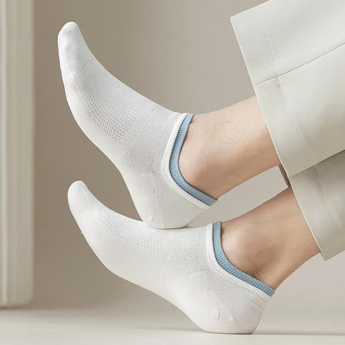 Men's white low-cut ankle socks with blue trim, breathable mesh, worn with light pants